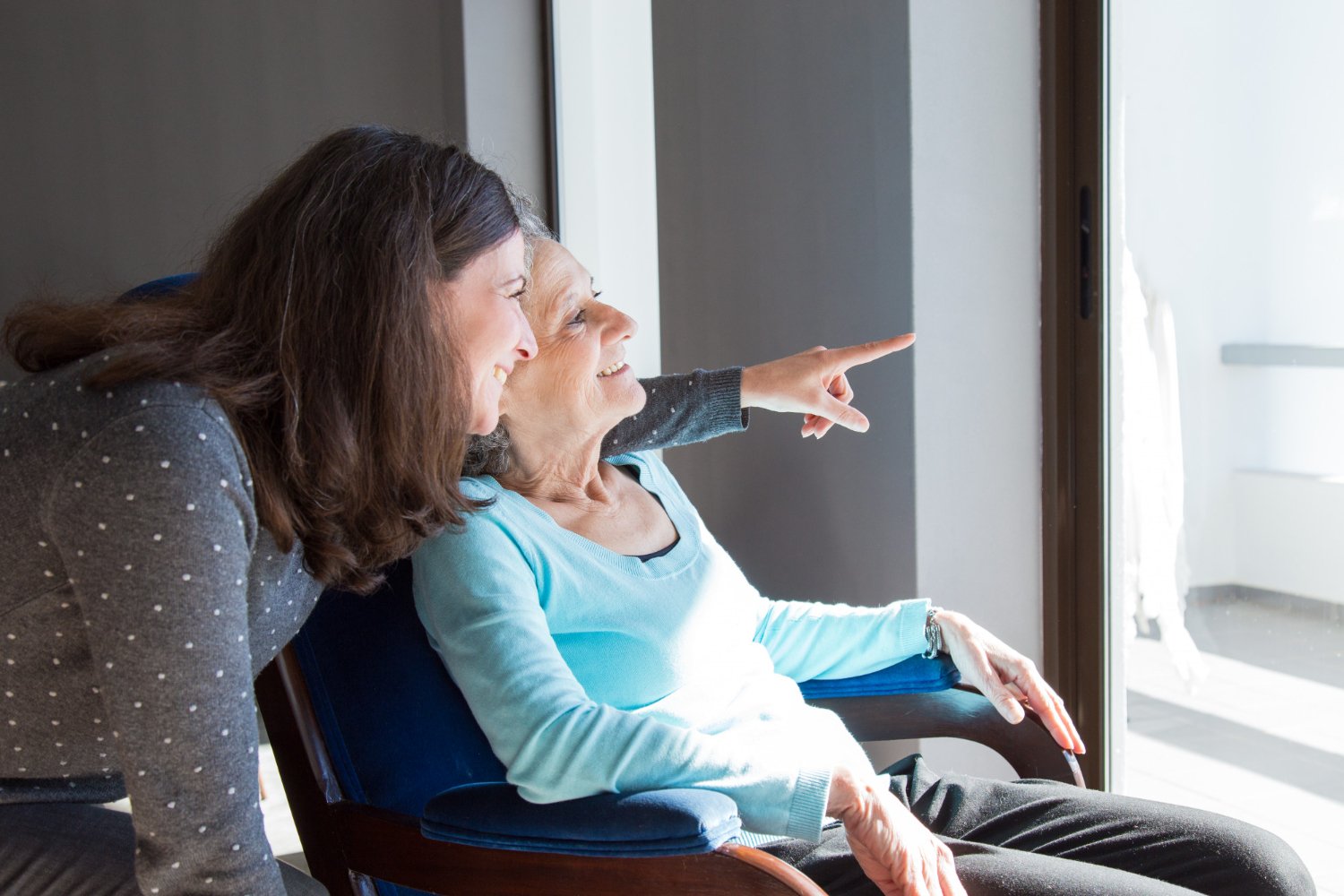 private caretaker with old woman in wheelchair